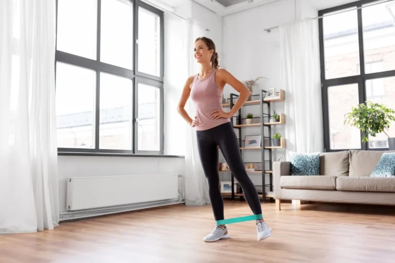 Woman over 40 doing modified strength training with resistance band at home