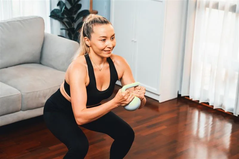 Woman over 40 doing strength training at home 