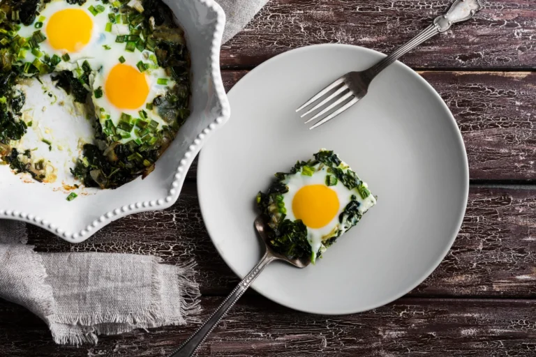 Spinach and feta scramble served on a white plate with fresh spinach