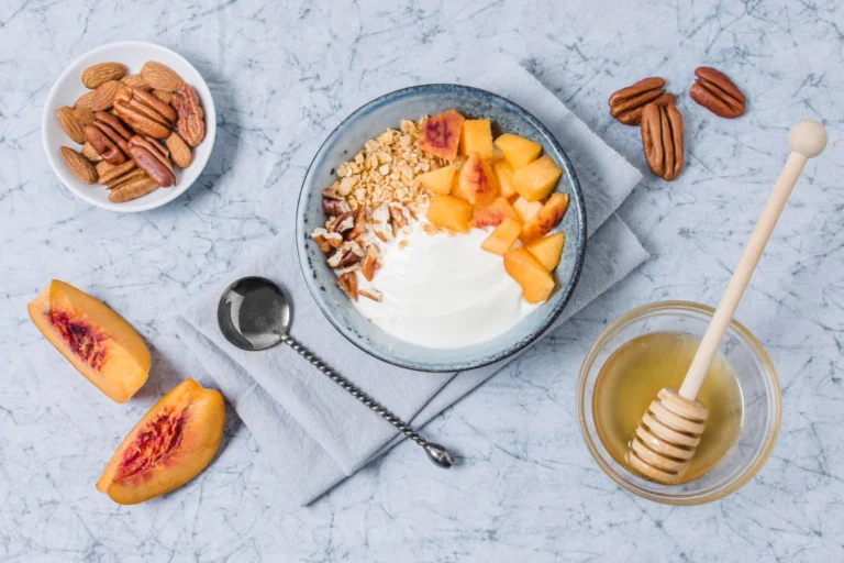 Cottage cheese stone fruit bowl with peaches, plums, and fresh berries — healthy protein breakfast
