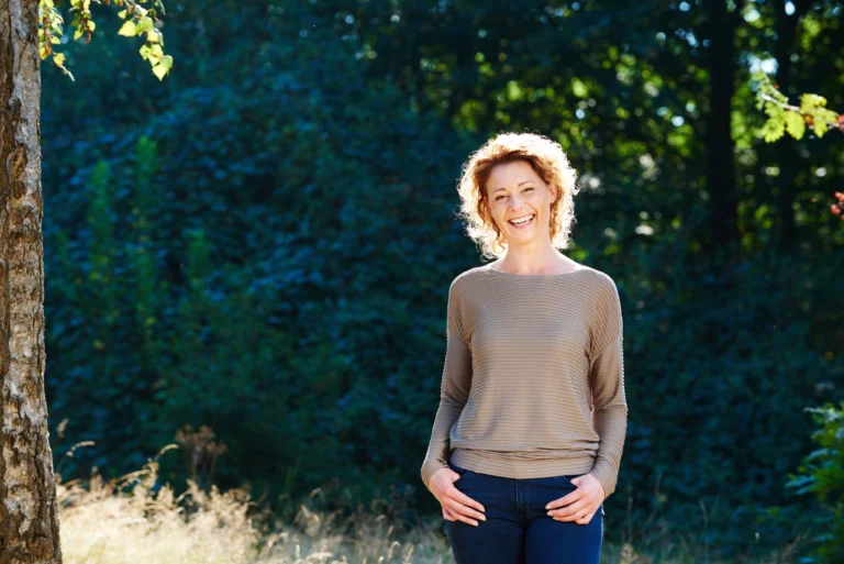 Woman smiling outdoors in natural light