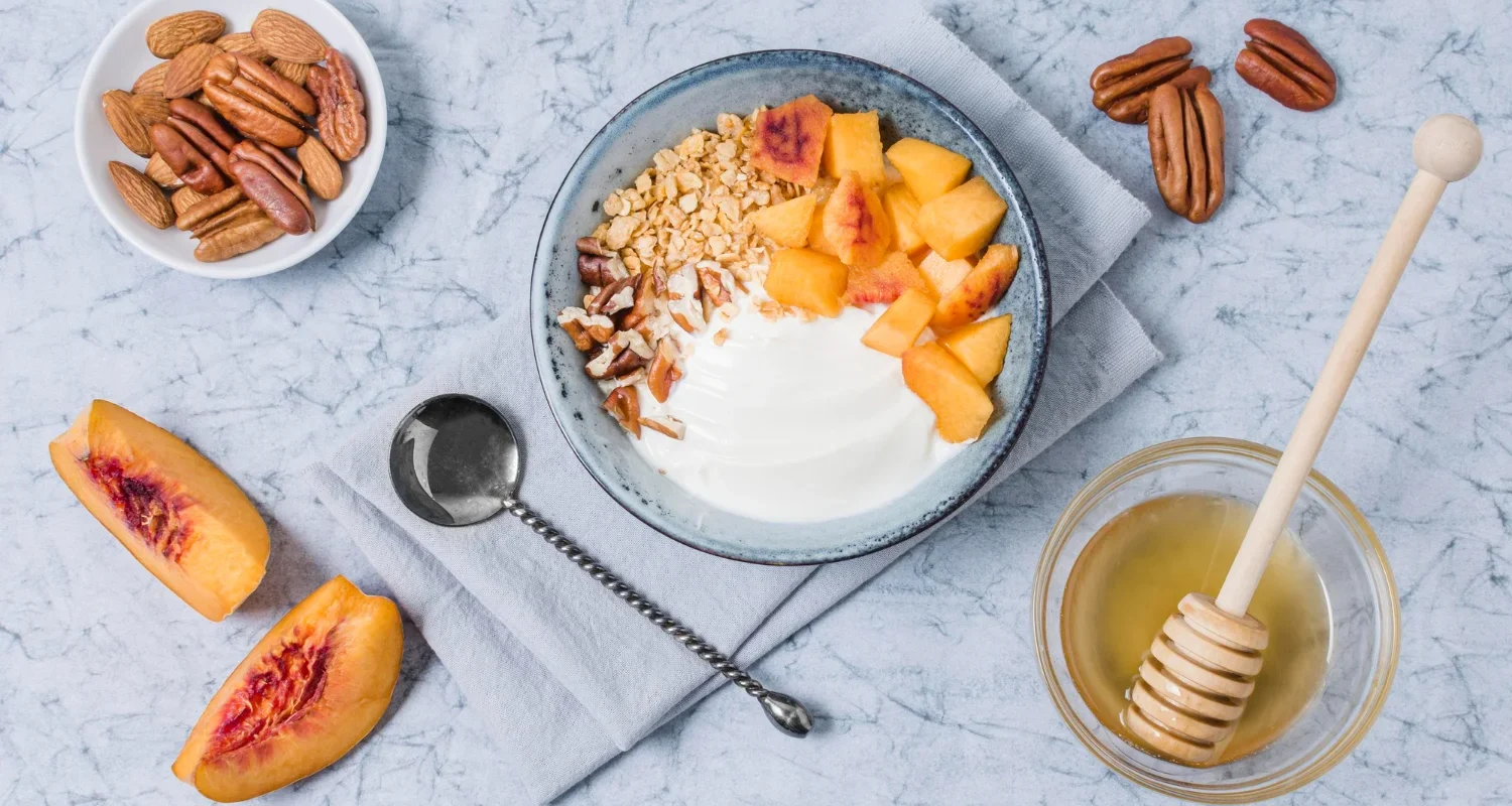 Cottage cheese topped with sliced peaches in a ceramic bowl
